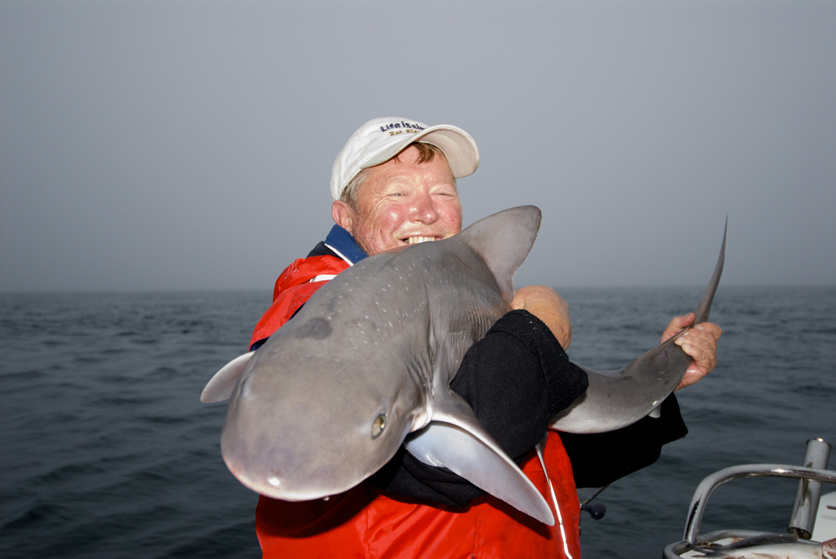 Steve Cooper shows off a 15kg gummy shark he caught in Western Port.