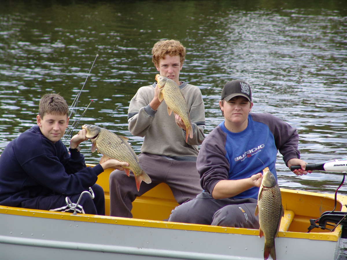Young anglers enjoy hooking carp.