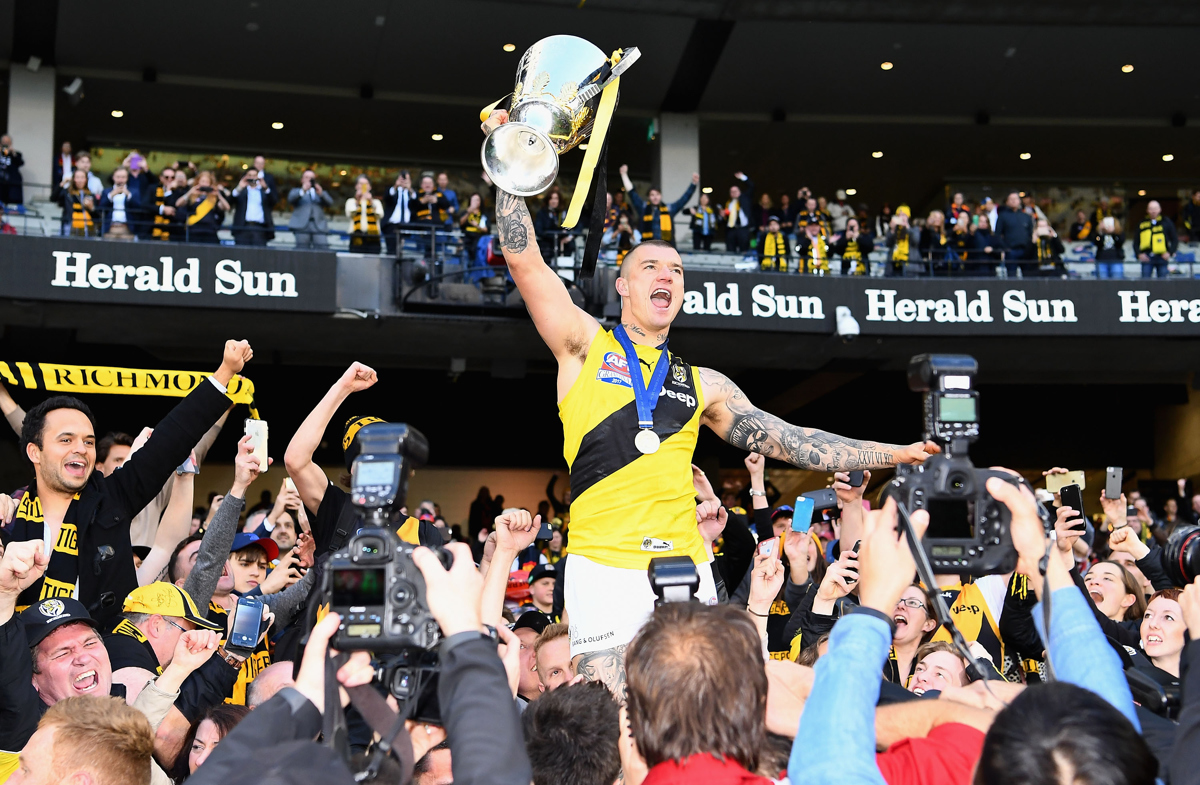 Dustin Martin celebrates with the Premiership Trophy