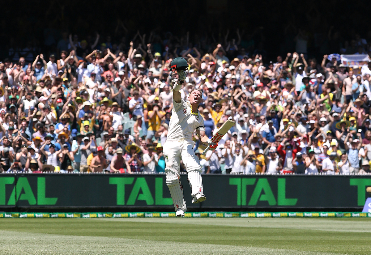 David Warner celebrates reaching his century at the MCG.