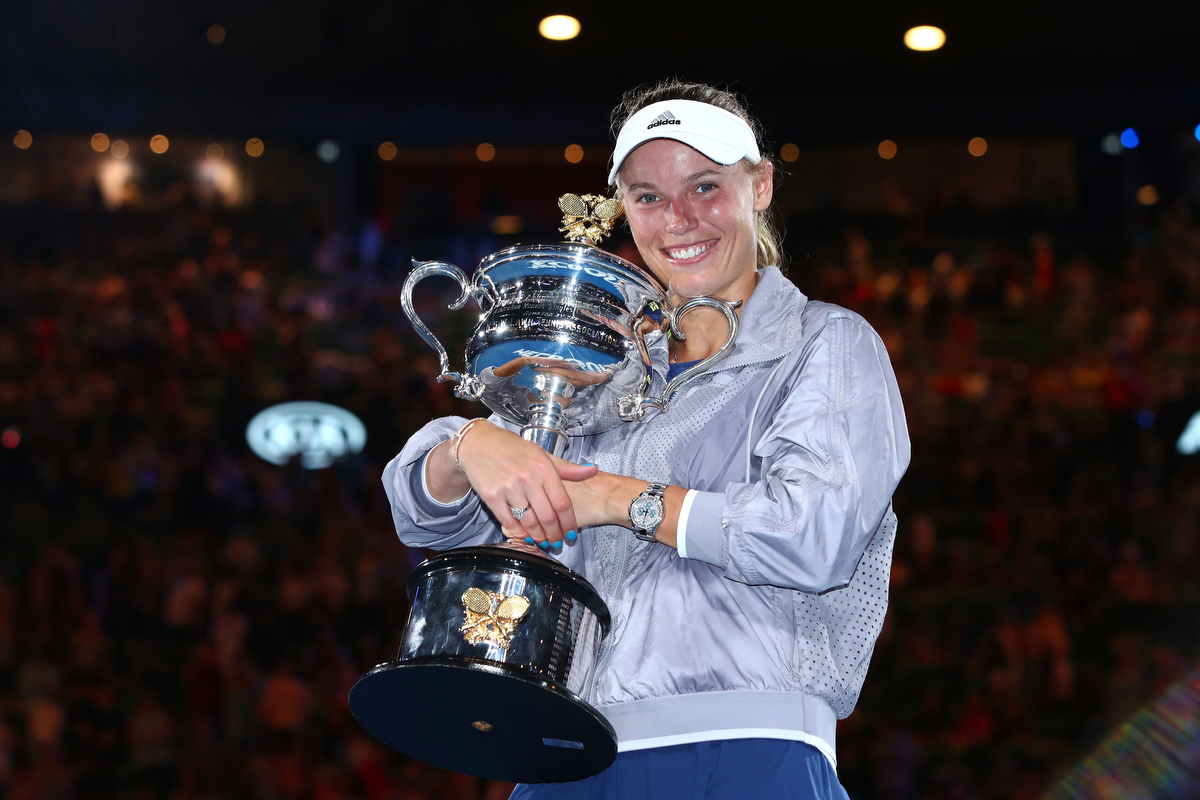 Caroline Wozniacki with the Daphne Akhurst Memorial Cup after winning the women's singles final against Simona Halep Pic: Clive Brunskill/Getty Images