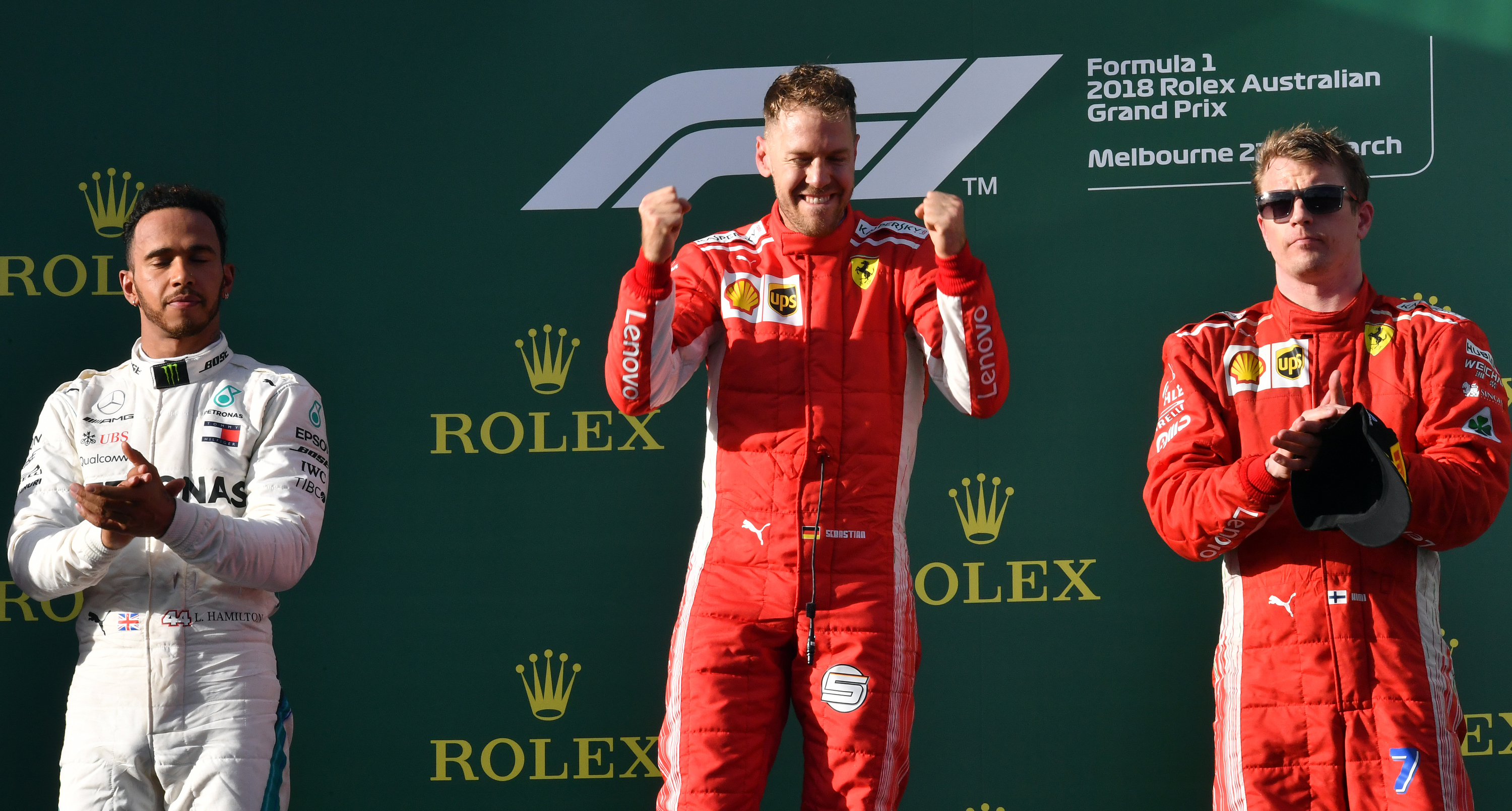 Sebastian Vettel (C) celebrates his victory on the podium next to second-placed Mercedes' British driver Lewis Hamilton (L) and third-placed Ferrari's Finnish driver Kimi Raikkonen (R) Pic:  SAEED KHAN/AFP/Getty Images