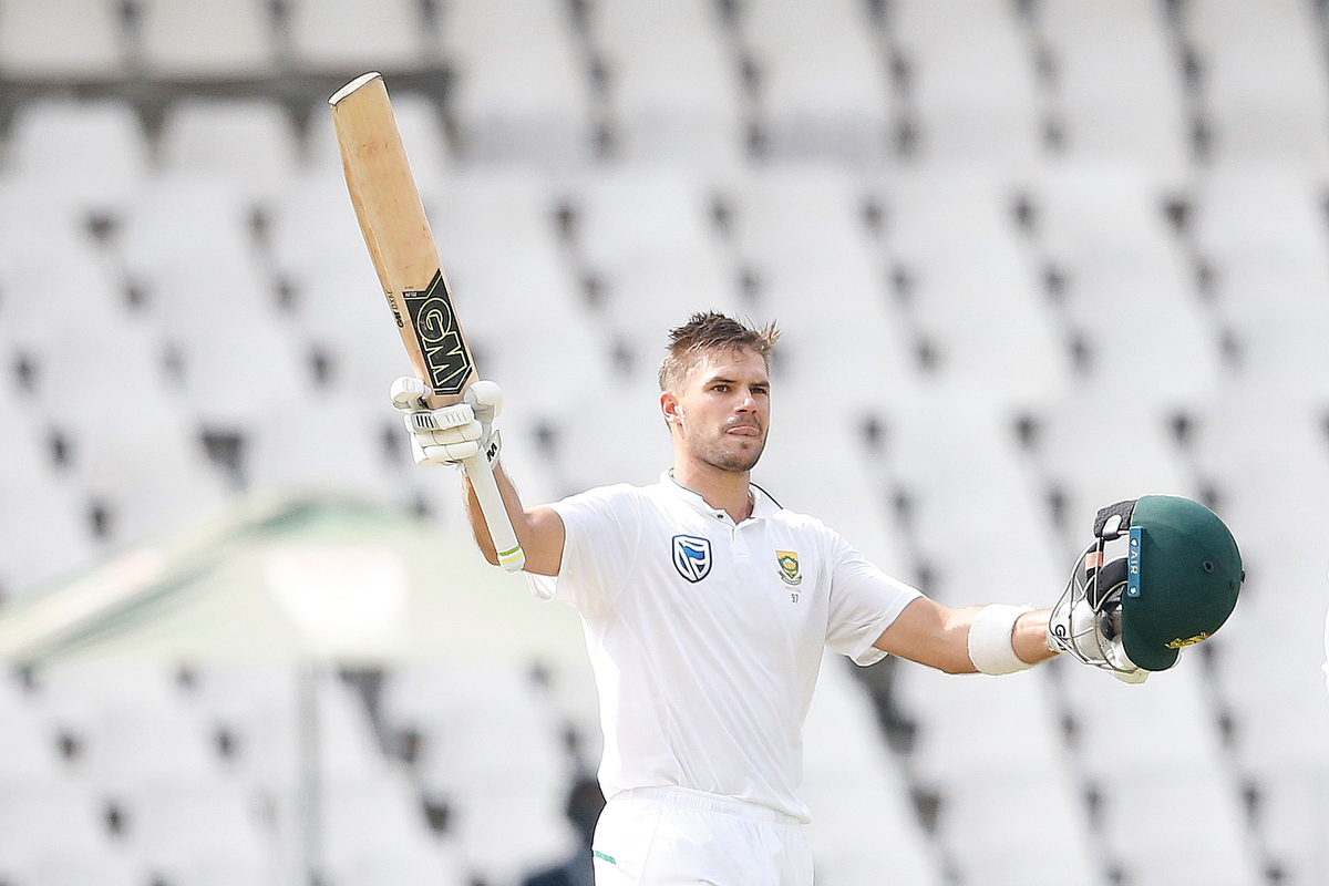 Rookie star Aiden Markram raises his bat and helmet as he celebrates scoring a century. Pic:  GIANLUIGI GUERCIA/AFP/Getty Images.