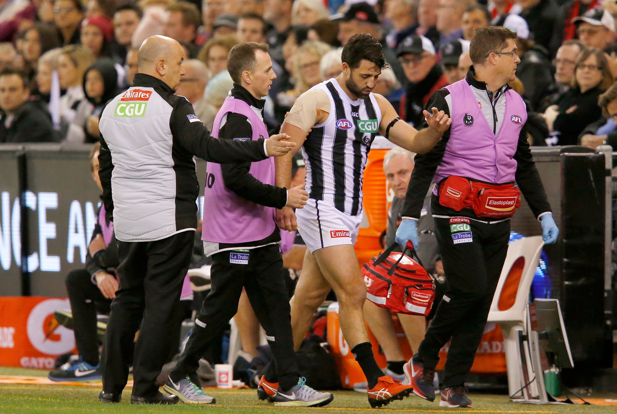 Alex Fasolo heads to the rooms for treatment after injuring his ankle. pic: Darrian Traynor/AFL Media/Getty Images