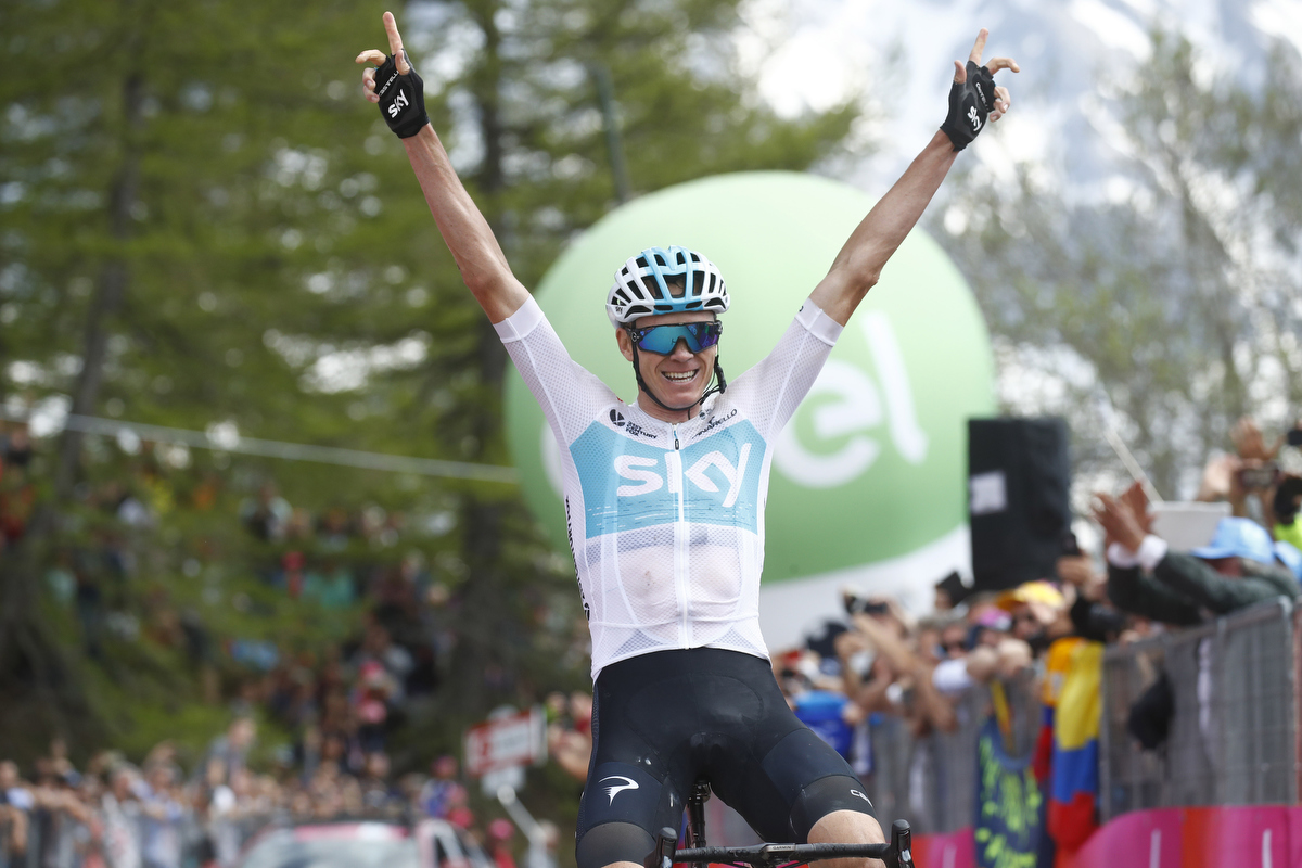 Christopher Froome crosses the finish line and wins the 19th stage. Pic:  LUK BENIES/AFP/Getty Images