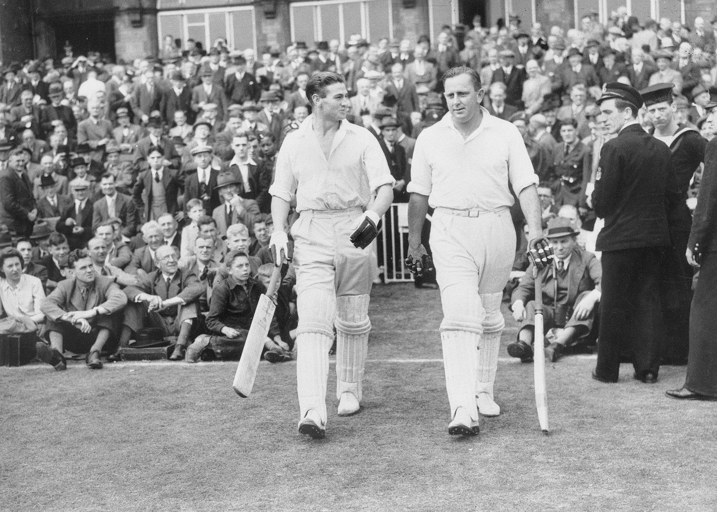 Keith Miller (left) and Cec Petter go out to bat in a Victory Test in 1945
