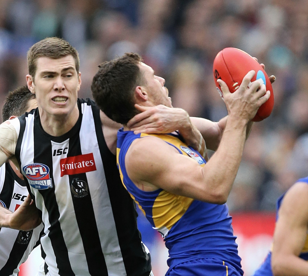 Mason Cox tackles Luke Shuey.